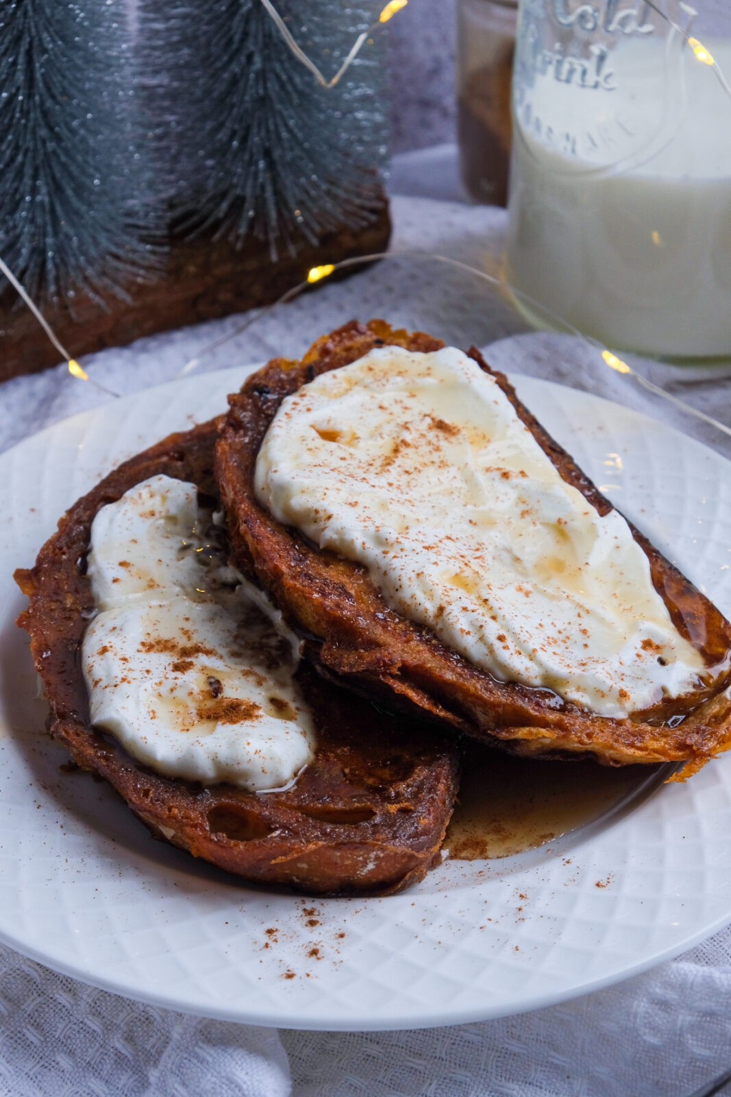 A picture of prepared gingerbread sourdough French toast surrounded by a few props for picture purposes only